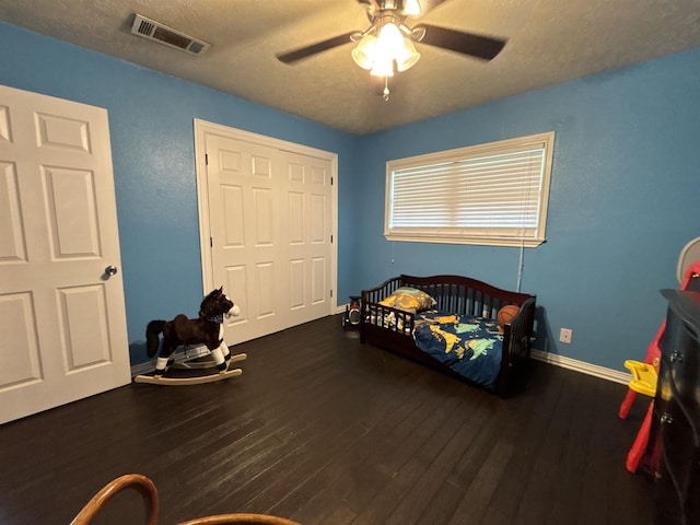 4400 Bethany St, Port Arthur, TX 77642 - bedroom with wood finished floors, baseboards, a ceiling fan, and a textured ceiling