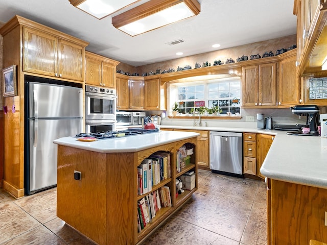 kitchen featuring sink, a kitchen island, and appliances with stainless steel finishes