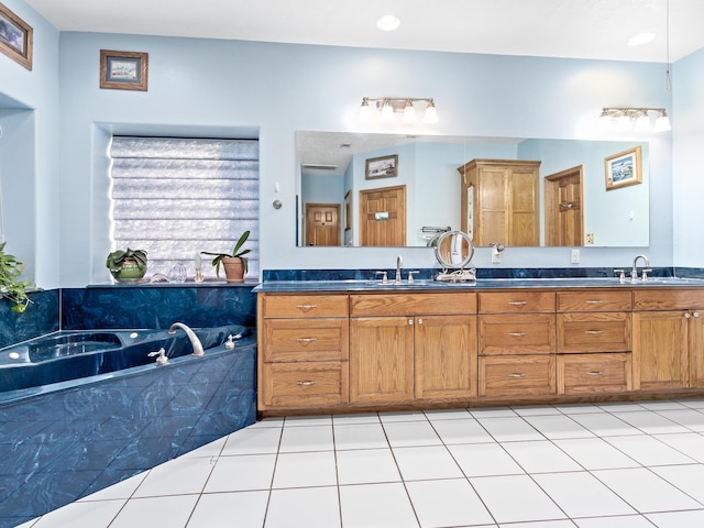 bathroom featuring tile patterned floors, a bathing tub, and vanity