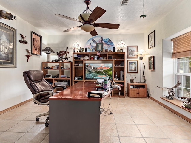 office area featuring ceiling fan, light tile patterned flooring, and a textured ceiling