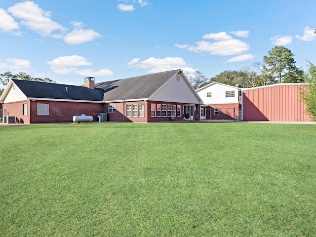 exterior space featuring a yard and central AC