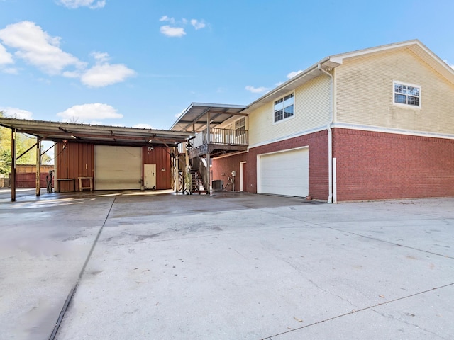 view of property exterior with a garage and central air condition unit