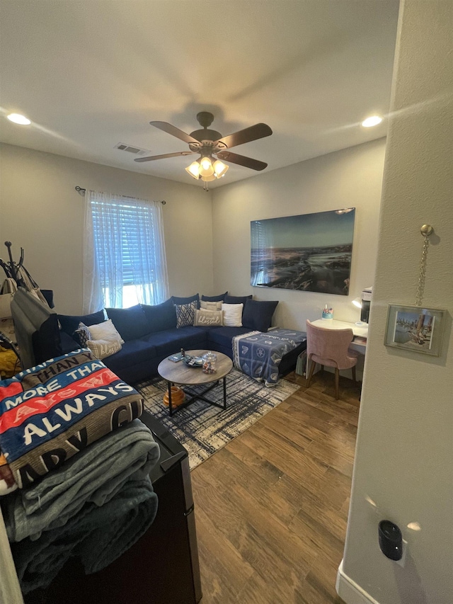 living room featuring ceiling fan and wood-type flooring