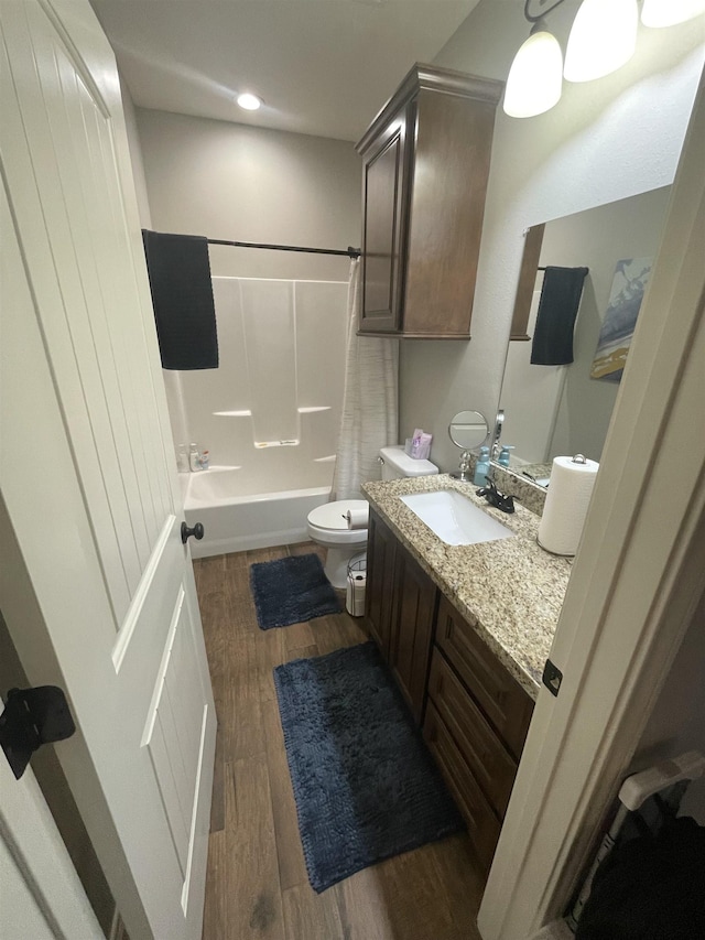 full bathroom featuring shower / tub combo, hardwood / wood-style floors, vanity, and toilet