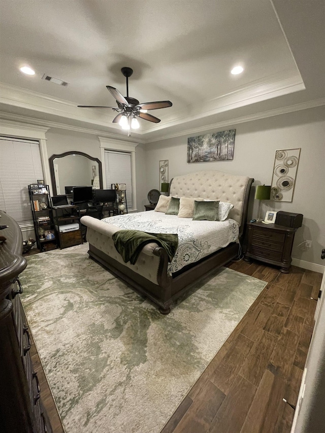 bedroom featuring a raised ceiling, ornamental molding, and ceiling fan