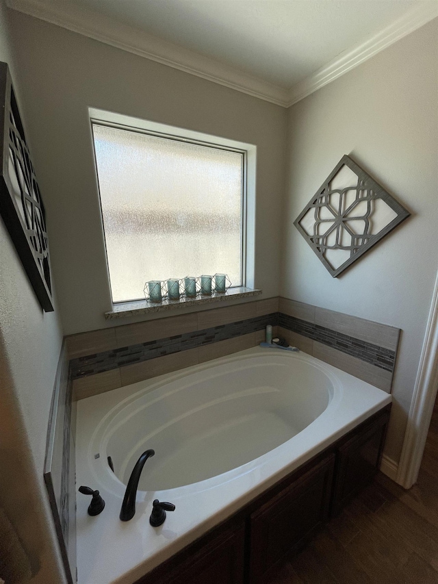 bathroom featuring a tub to relax in and ornamental molding