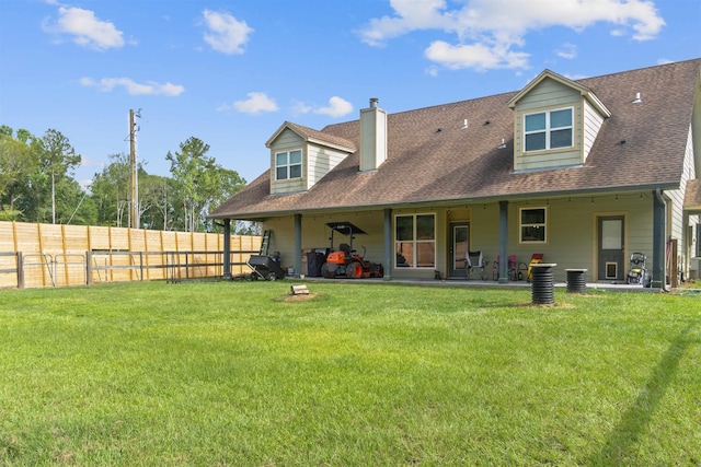 back of property with a yard, cooling unit, and a patio area