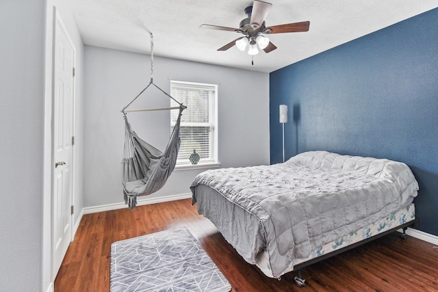 bedroom with hardwood / wood-style flooring and ceiling fan