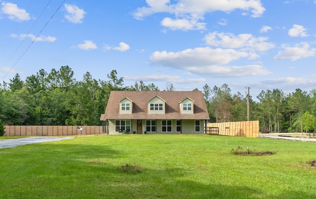 new england style home featuring a front yard