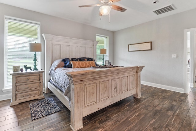 bedroom featuring multiple windows, ceiling fan, and dark hardwood / wood-style flooring