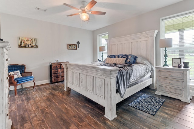 bedroom with dark hardwood / wood-style flooring and ceiling fan