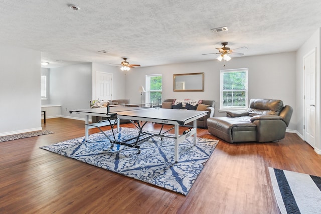 rec room featuring wood-type flooring, plenty of natural light, and ceiling fan