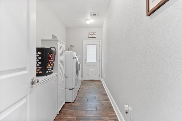 clothes washing area featuring washer and dryer and dark hardwood / wood-style flooring