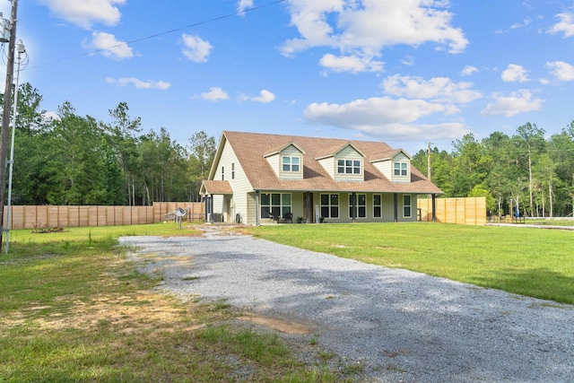 cape cod-style house with a front yard