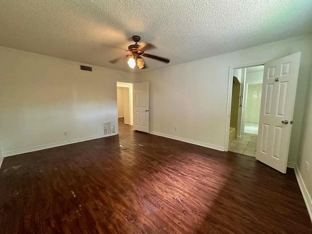 790 Pinchback Rd, Beaumont, TX 77707 - unfurnished bedroom featuring dark wood finished floors, a textured ceiling, baseboards, and a ceiling fan