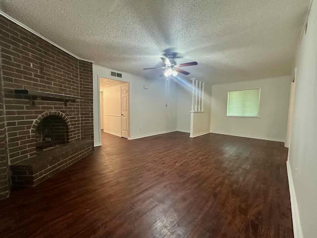 790 Pinchback Rd, Beaumont, TX 77707 - unfurnished living room featuring ceiling fan, wood finished floors, a textured ceiling, a brick fireplace, and baseboards