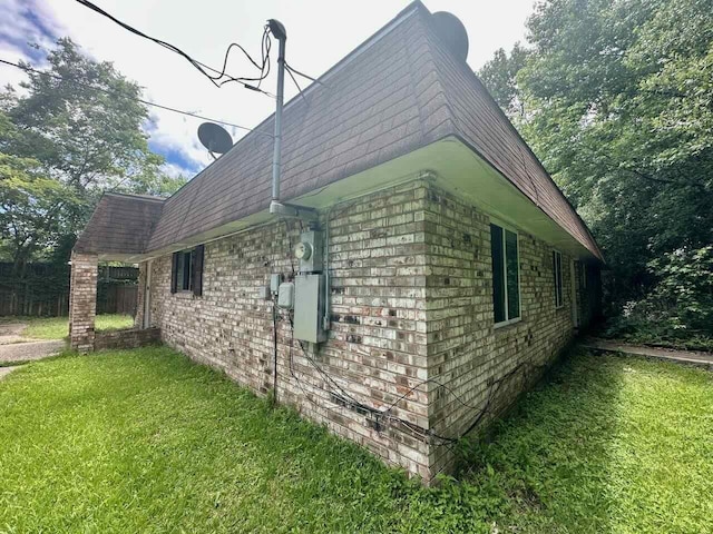 790 Pinchback Rd, Beaumont, TX 77707 - view of side of property featuring a lawn, mansard roof, brick siding, and a shingled roof