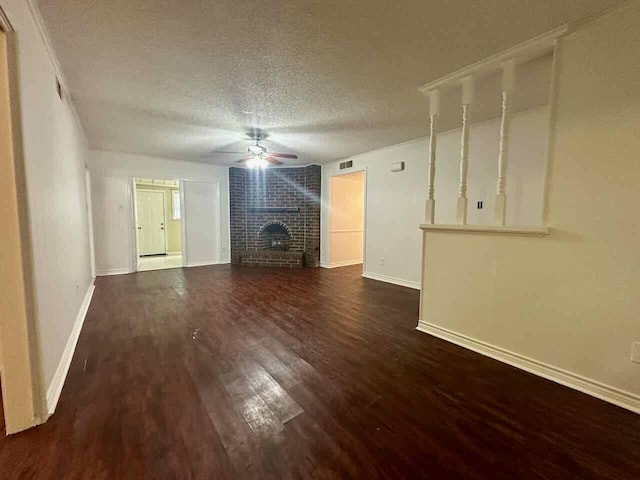 790 Pinchback Rd, Beaumont, TX 77707 - unfurnished living room featuring a fireplace, dark wood-type flooring, a textured ceiling, and baseboards
