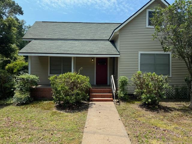 bungalow-style home with a front lawn