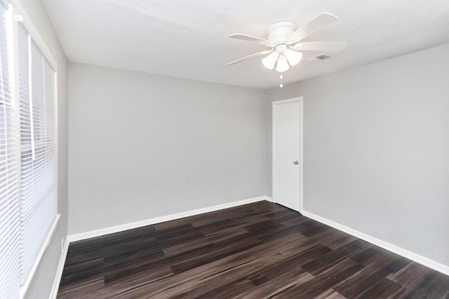 empty room featuring dark hardwood / wood-style floors and ceiling fan