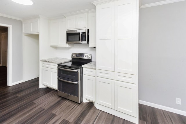 kitchen featuring light stone counters, appliances with stainless steel finishes, crown molding, and white cabinets