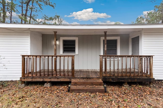 view of exterior entry featuring covered porch