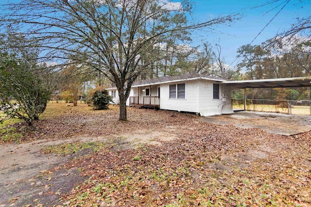 view of side of property featuring a carport