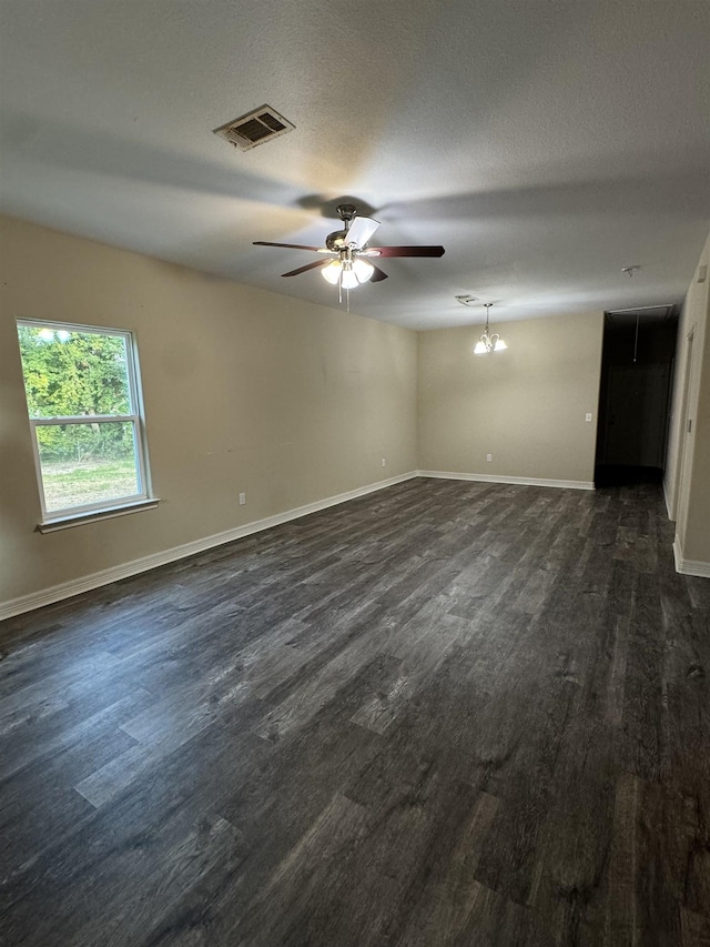 spare room with a textured ceiling and ceiling fan with notable chandelier