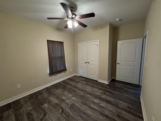 unfurnished bedroom featuring a closet, ceiling fan, and dark hardwood / wood-style flooring