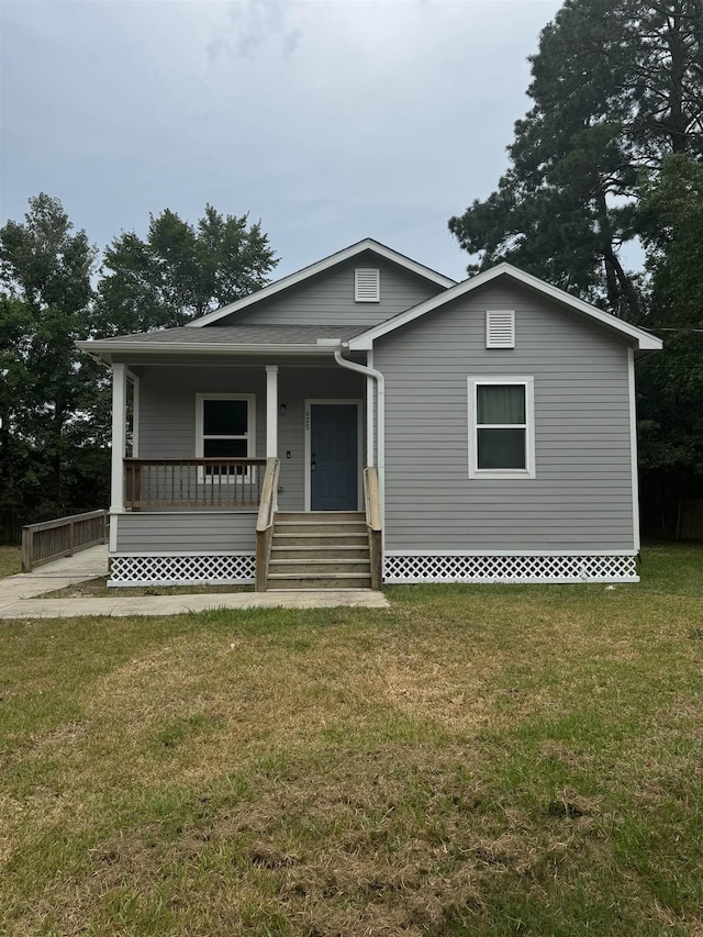 view of front facade with a front lawn and a porch