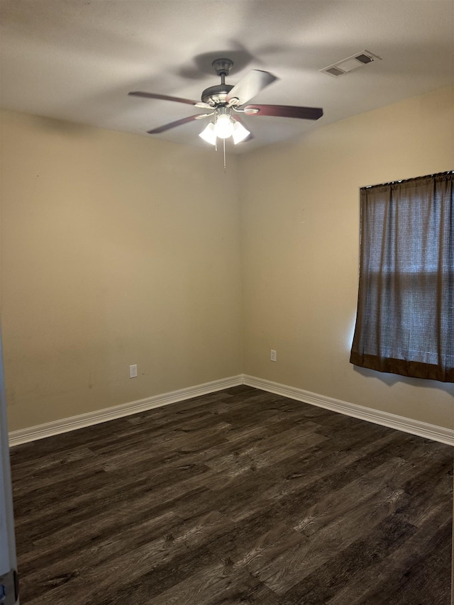 unfurnished room with ceiling fan and dark hardwood / wood-style flooring