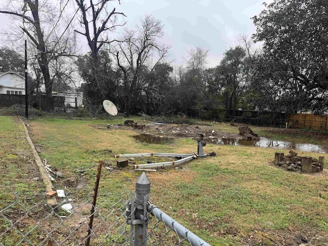 view of yard featuring a water view and fence