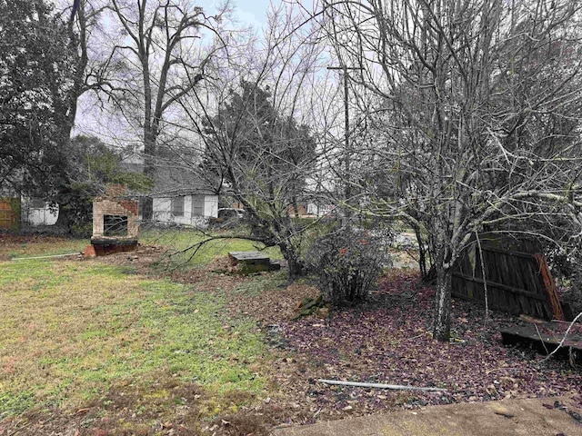 view of yard with an outdoor stone fireplace