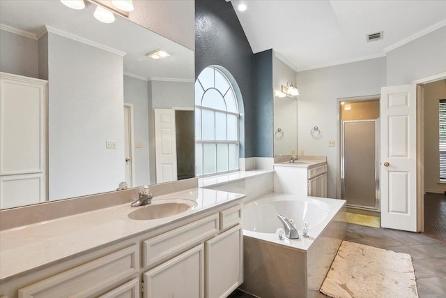 bathroom featuring independent shower and bath, crown molding, vanity, and tile patterned floors