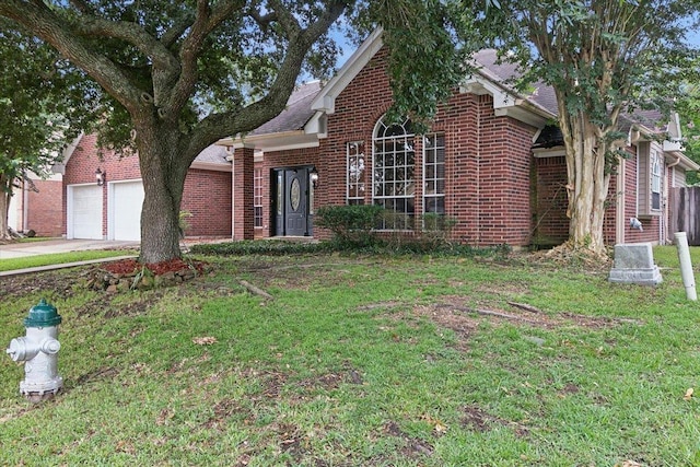 view of front of home with a garage and a front yard