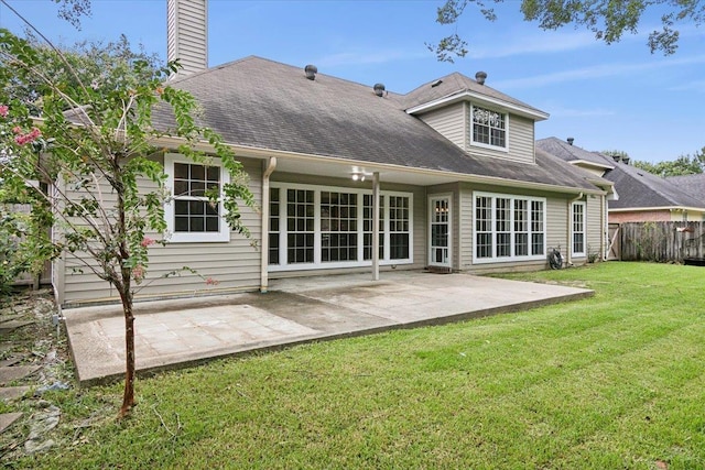 back of property featuring a patio area and a lawn