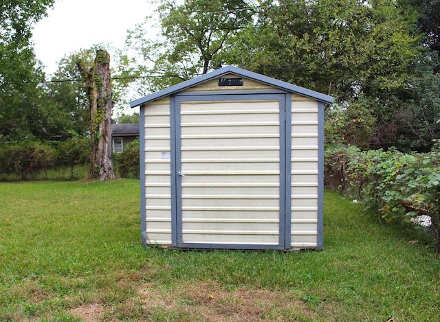 view of outbuilding with a yard