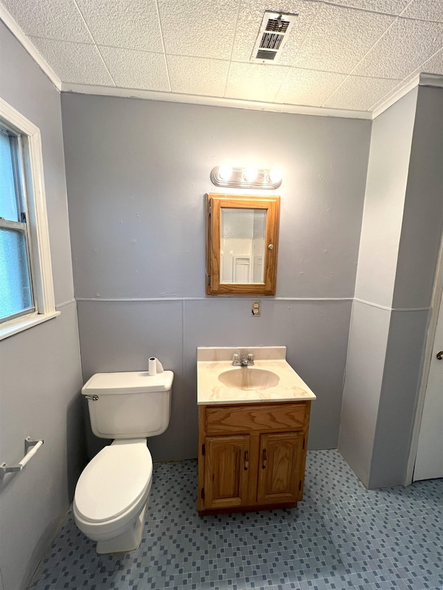 bathroom with crown molding, vanity, and toilet