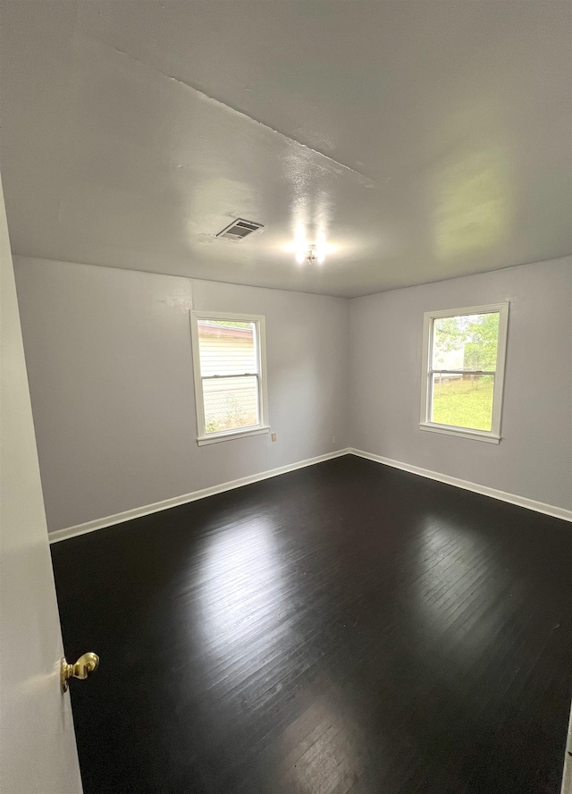 spare room with wood-type flooring