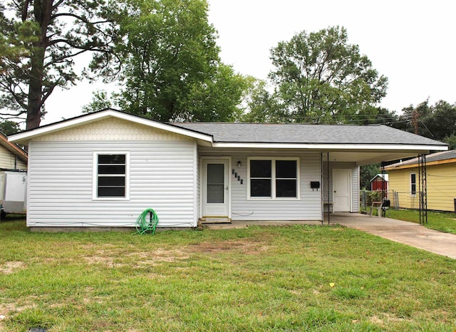 single story home with a front lawn and a carport