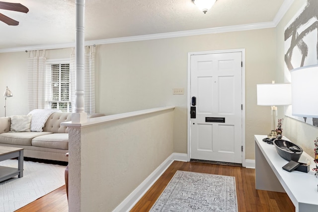 entryway featuring ceiling fan, dark hardwood / wood-style flooring, and ornamental molding