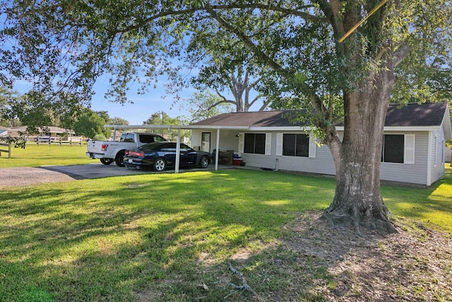 single story home with a front lawn and a carport