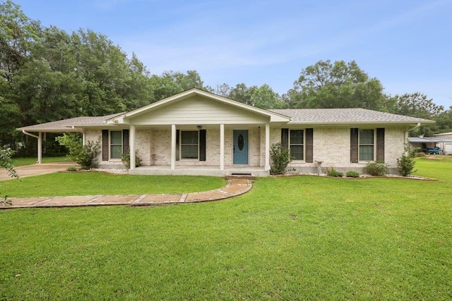 ranch-style home with covered porch, brick siding, a front lawn, and an attached carport