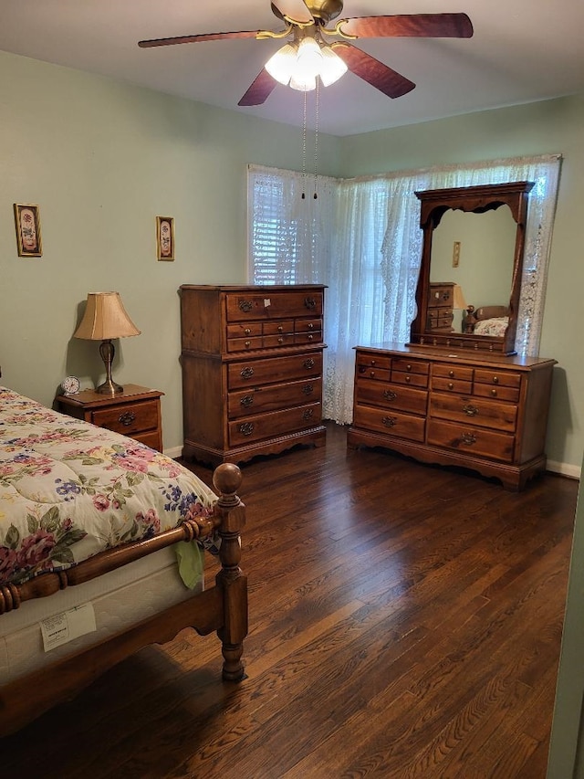 bedroom with dark hardwood / wood-style floors and ceiling fan