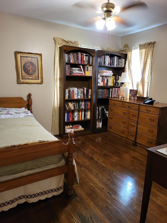 bedroom with ceiling fan and dark wood-type flooring