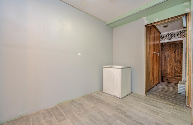 spare room featuring light hardwood / wood-style flooring