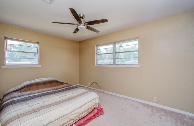 bedroom featuring light colored carpet and ceiling fan