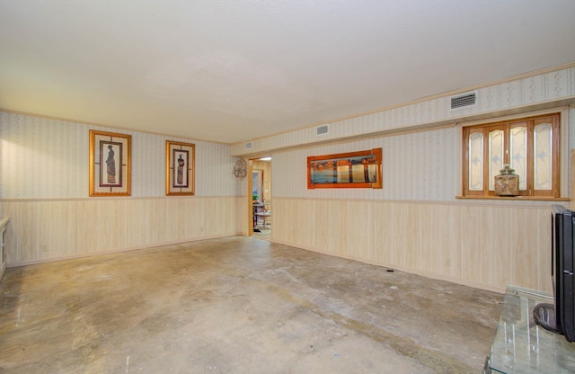 interior space with wooden walls and concrete floors