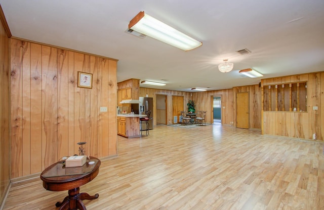 interior space featuring wood walls and light hardwood / wood-style flooring