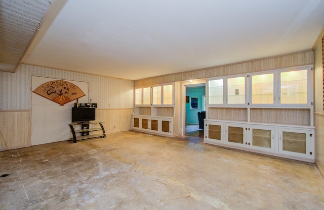 unfurnished living room with concrete floors